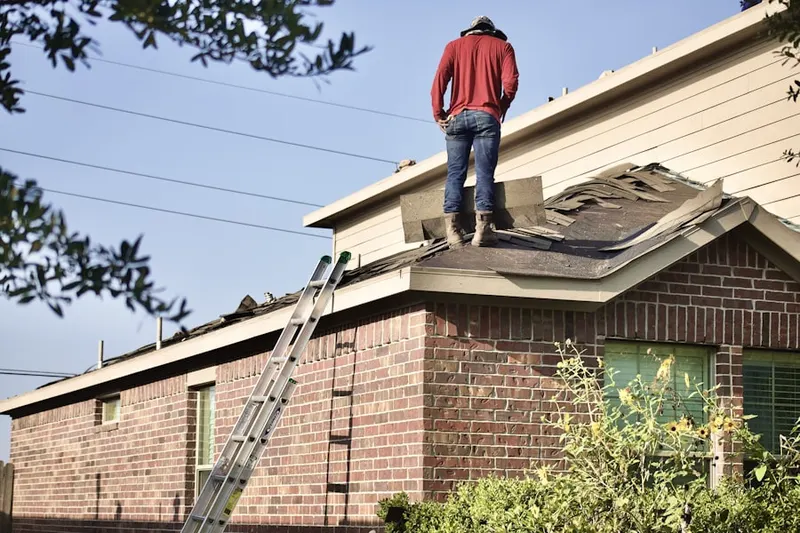 Professional roofer working on a residential roof in East Hemet